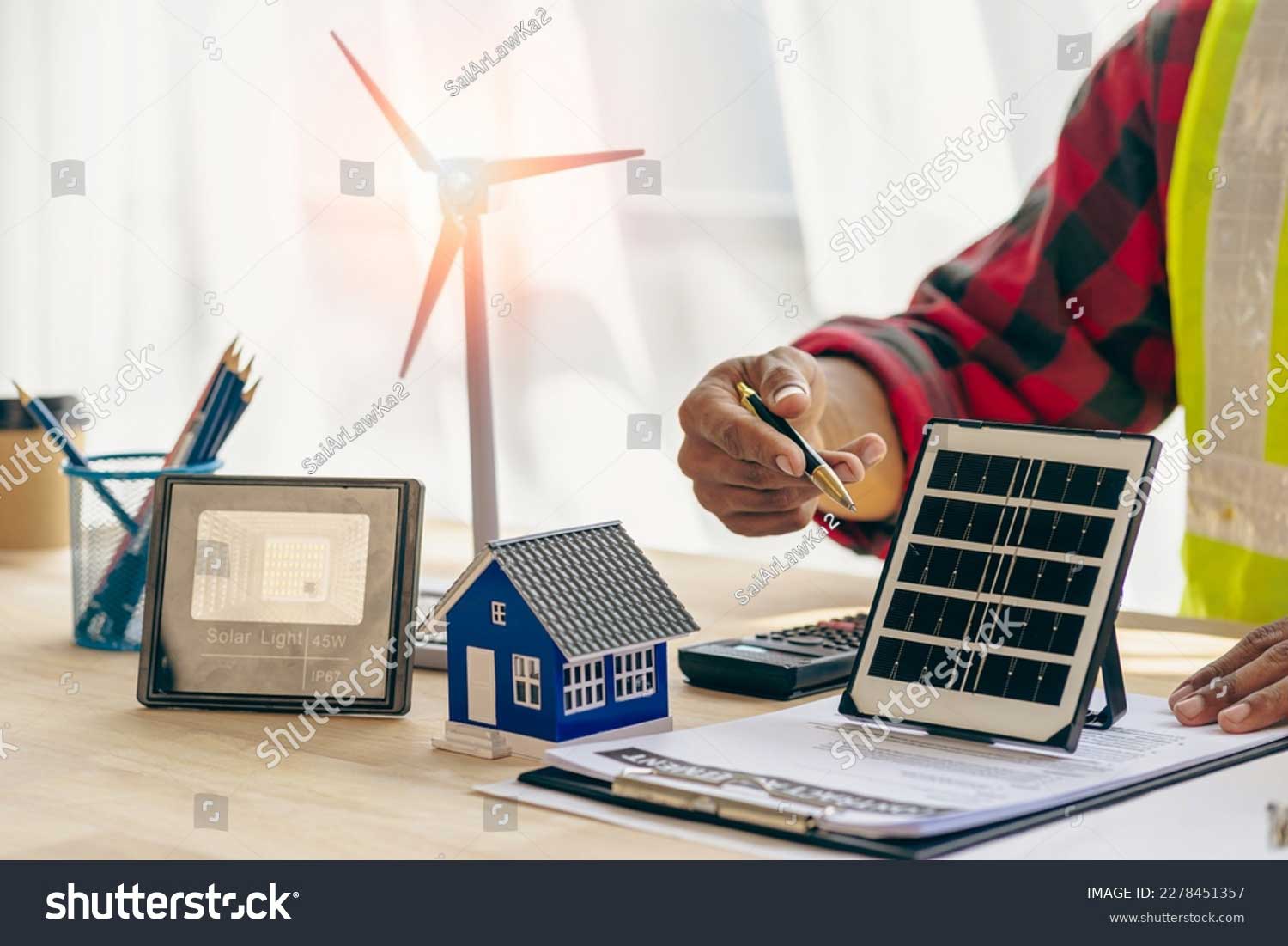 stock photo engineer working in office at desk with solar laptop and concept home design solar renewable energy 2278451357